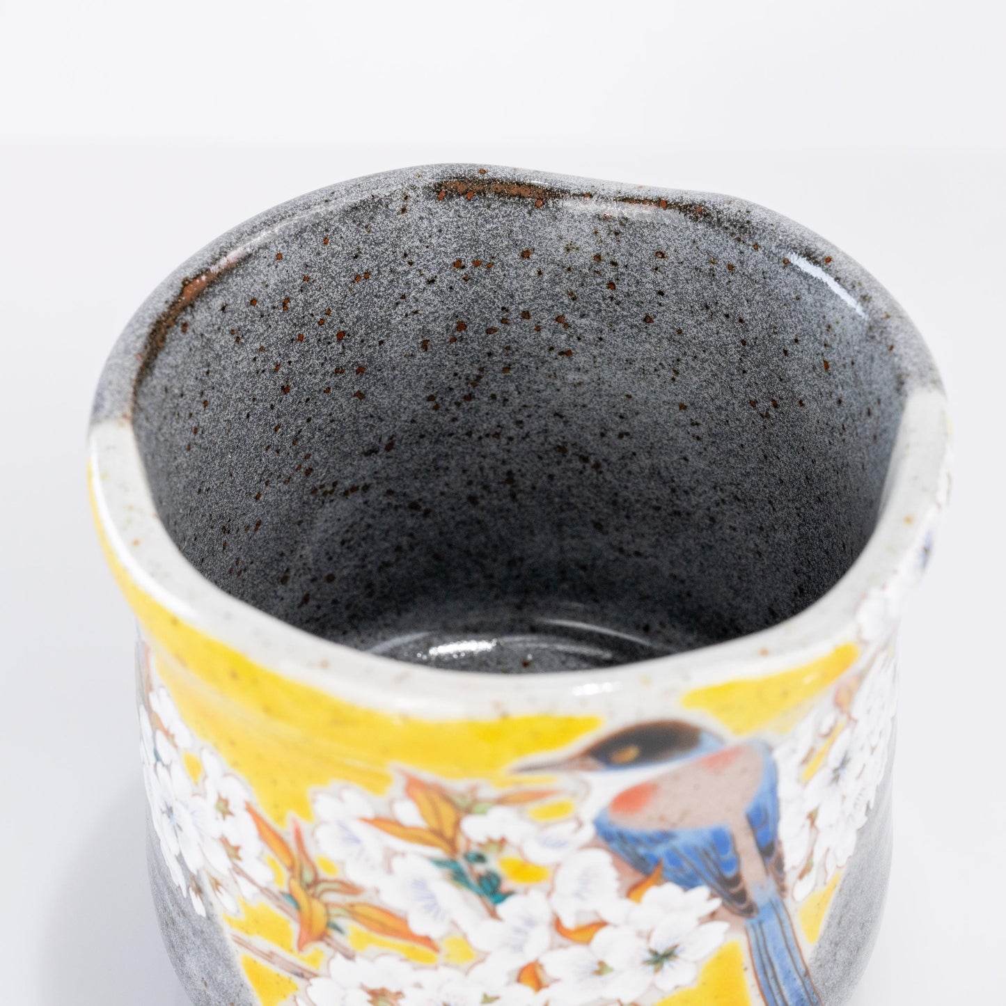 Top angled view of a Kutani ware sakura bird tea cup