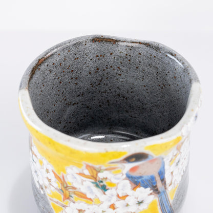 Top angled view of a Kutani ware sakura bird tea cup