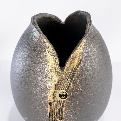 Angled view of handmade Shigaraki black gold vase