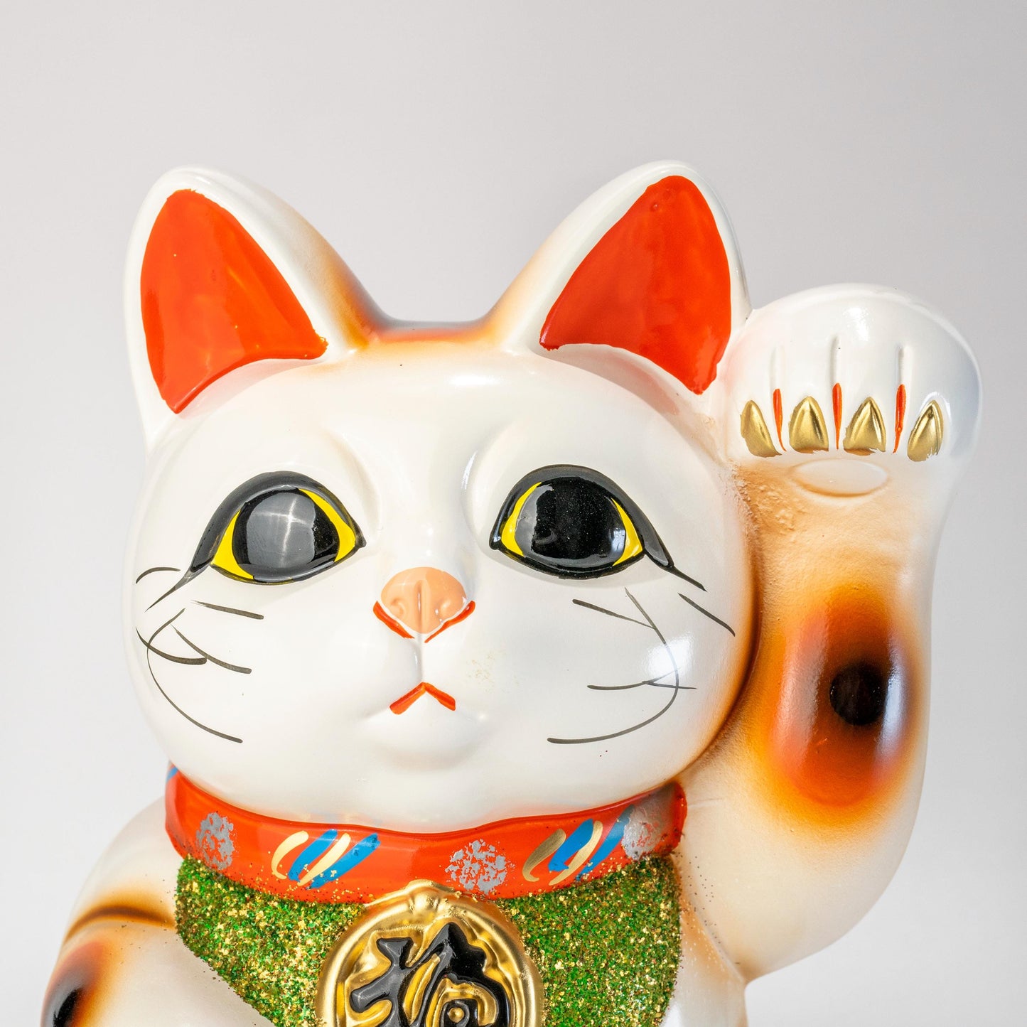 Angled front view of white Tokoname Maneki Neko lucky cat statue