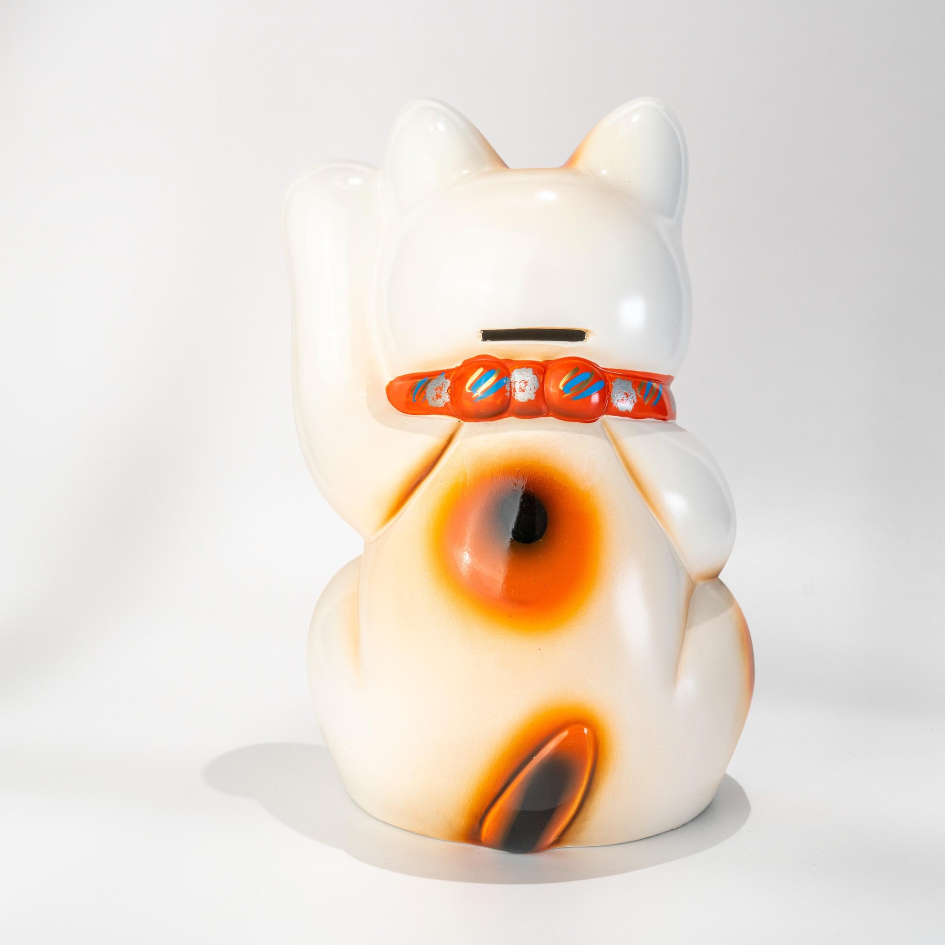 Back view of Tokoname Maneki Neko statue in white ceramic