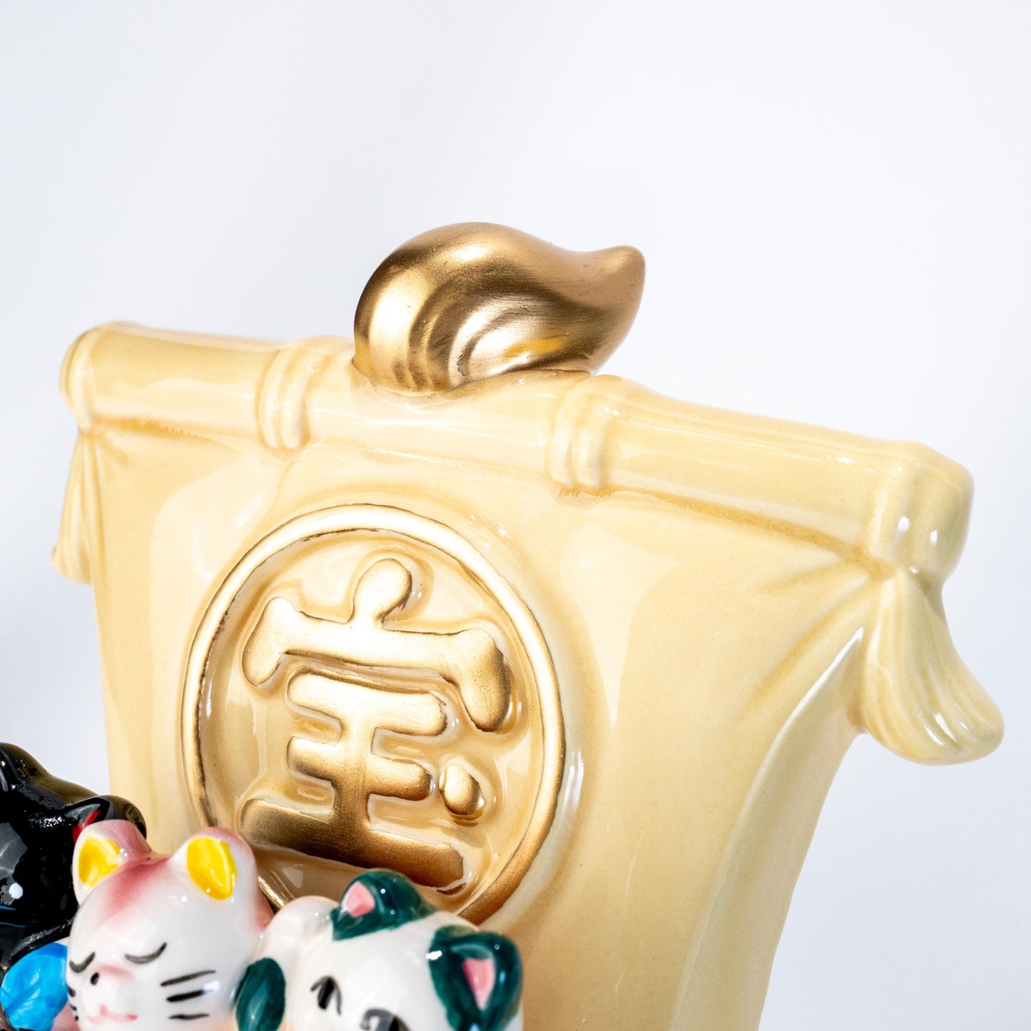 Close-up of decorative lucky cats on treasure ship