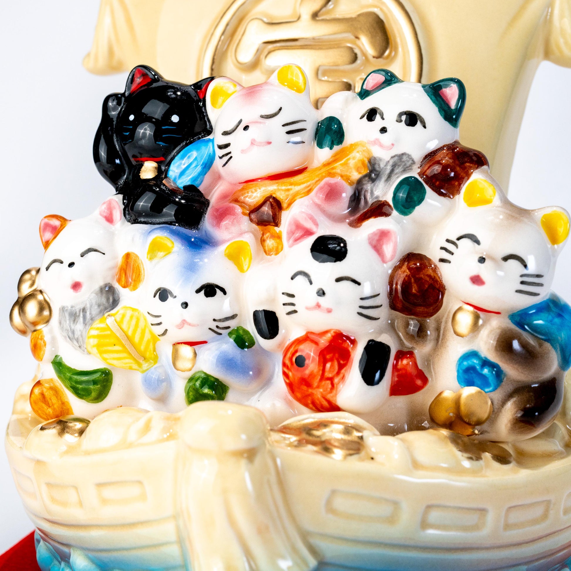 Front detail of cats on a ceramic treasure ship figurine