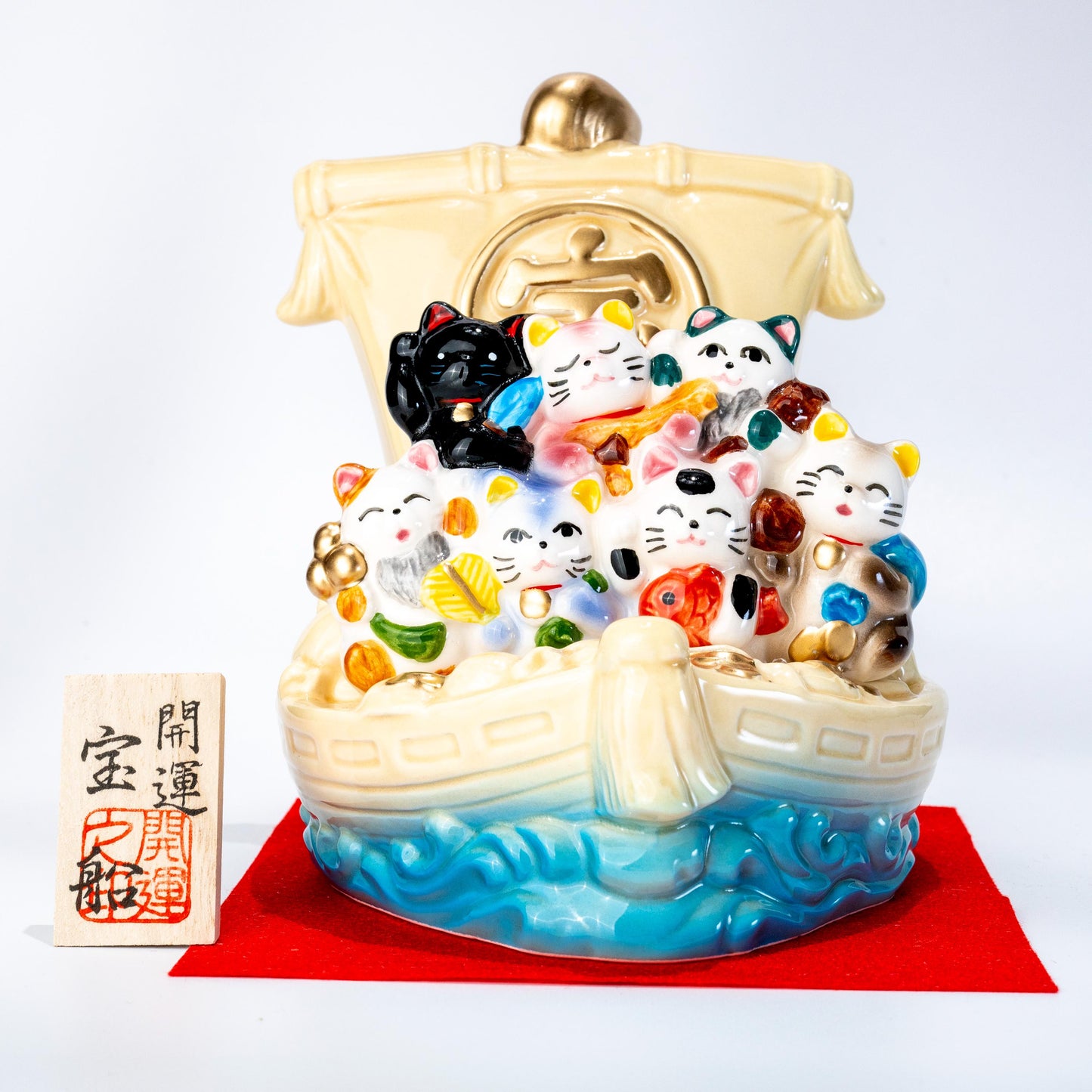 Seven lucky cats treasure ship figurine in Seto ware on red cloth