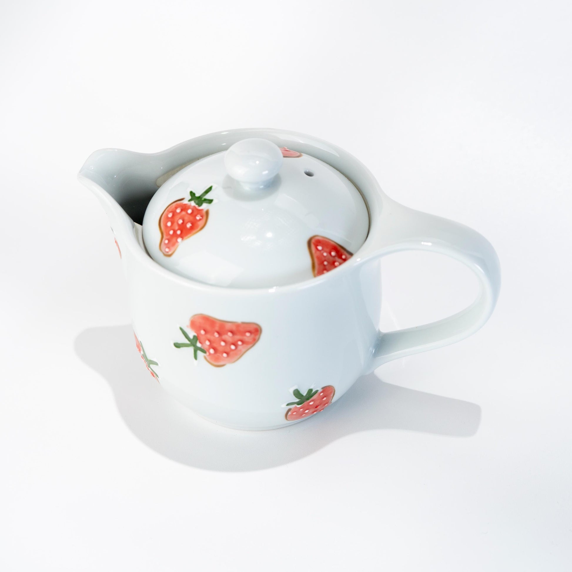 Arita strawberry teapot in hand-painted porcelain on white background