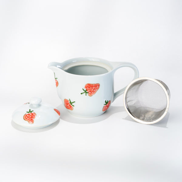 Angled view of Arita strawberry teapot with built-in strainer