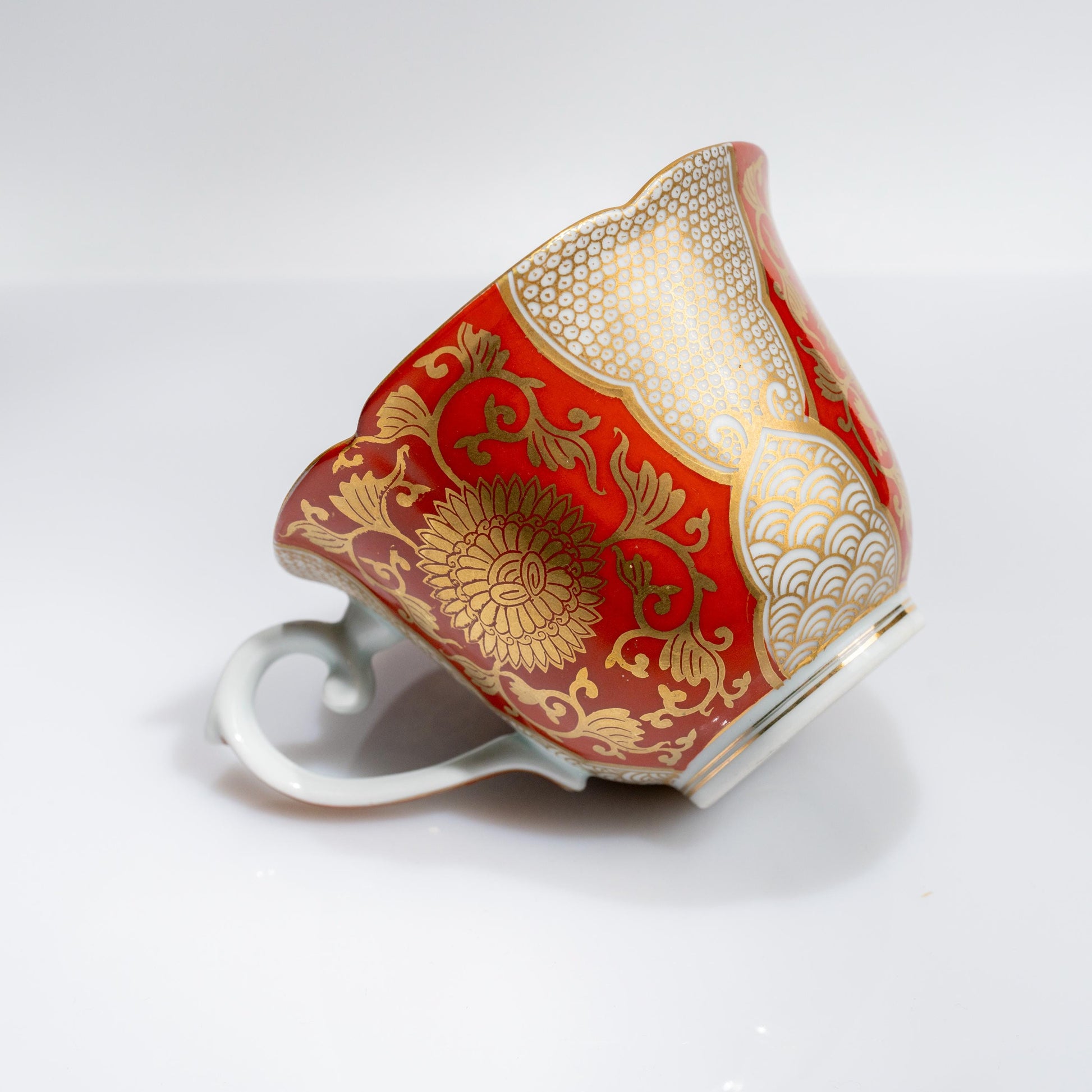 Close-up of cup handle and painted chrysanthemum design