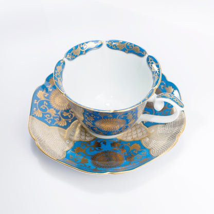 Side view of Arita porcelain cup with blue and gold floral motif