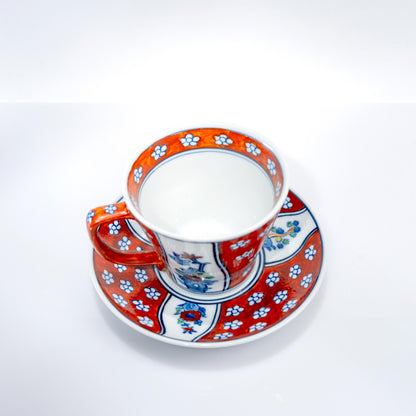 Top view of hand-painted cup and saucer with Four Gentlemen motif