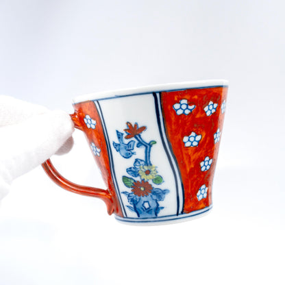 Angled view of red and blue porcelain cup and saucer set