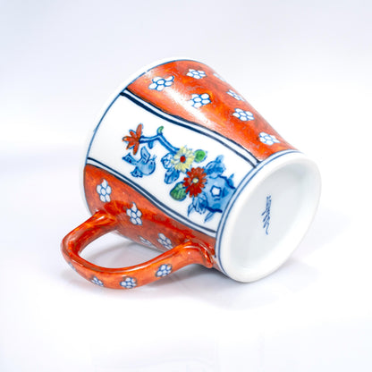 Side view of Arita hand-painted coffee cup with red floral detail