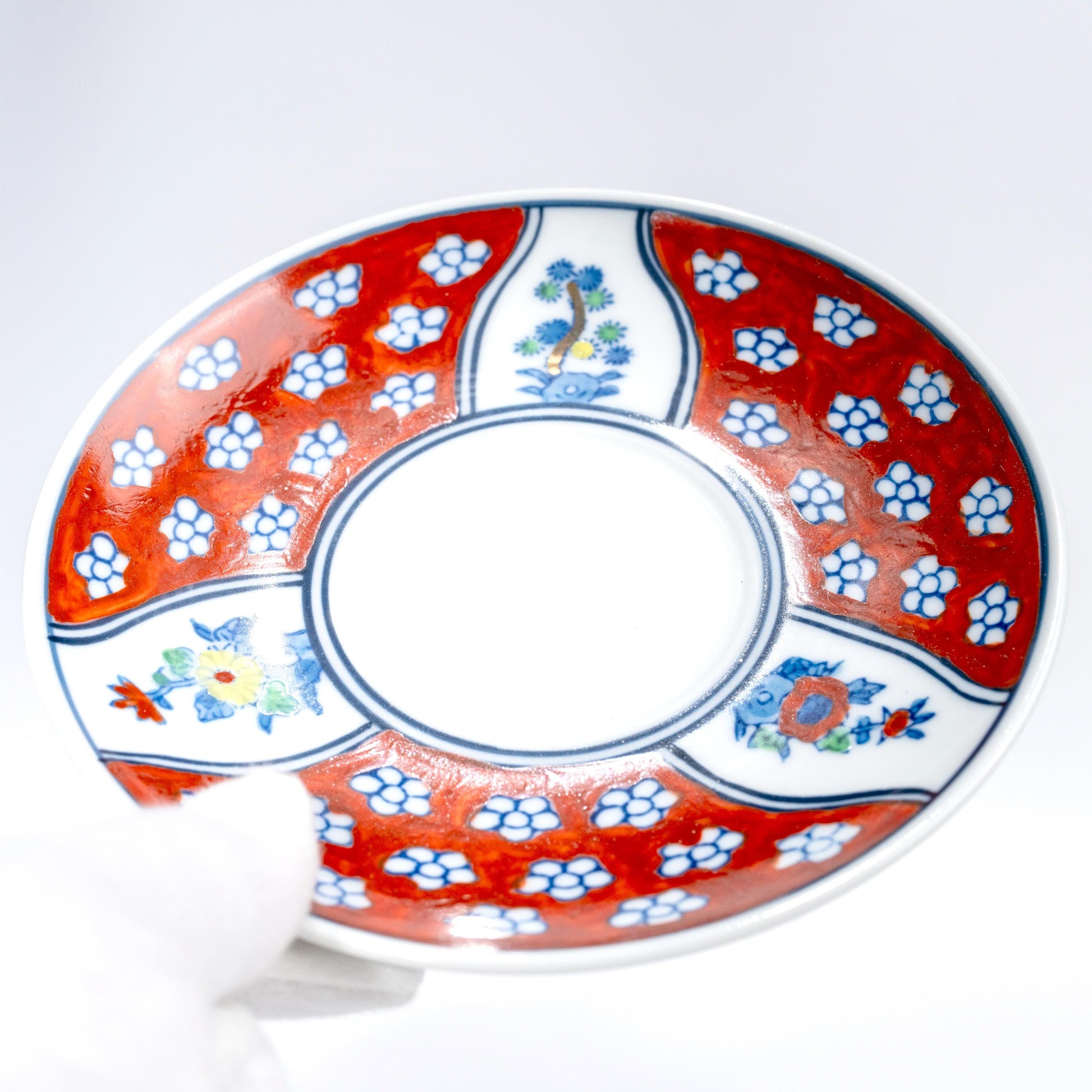 Top view of saucer showing Four Gentlemen decoration