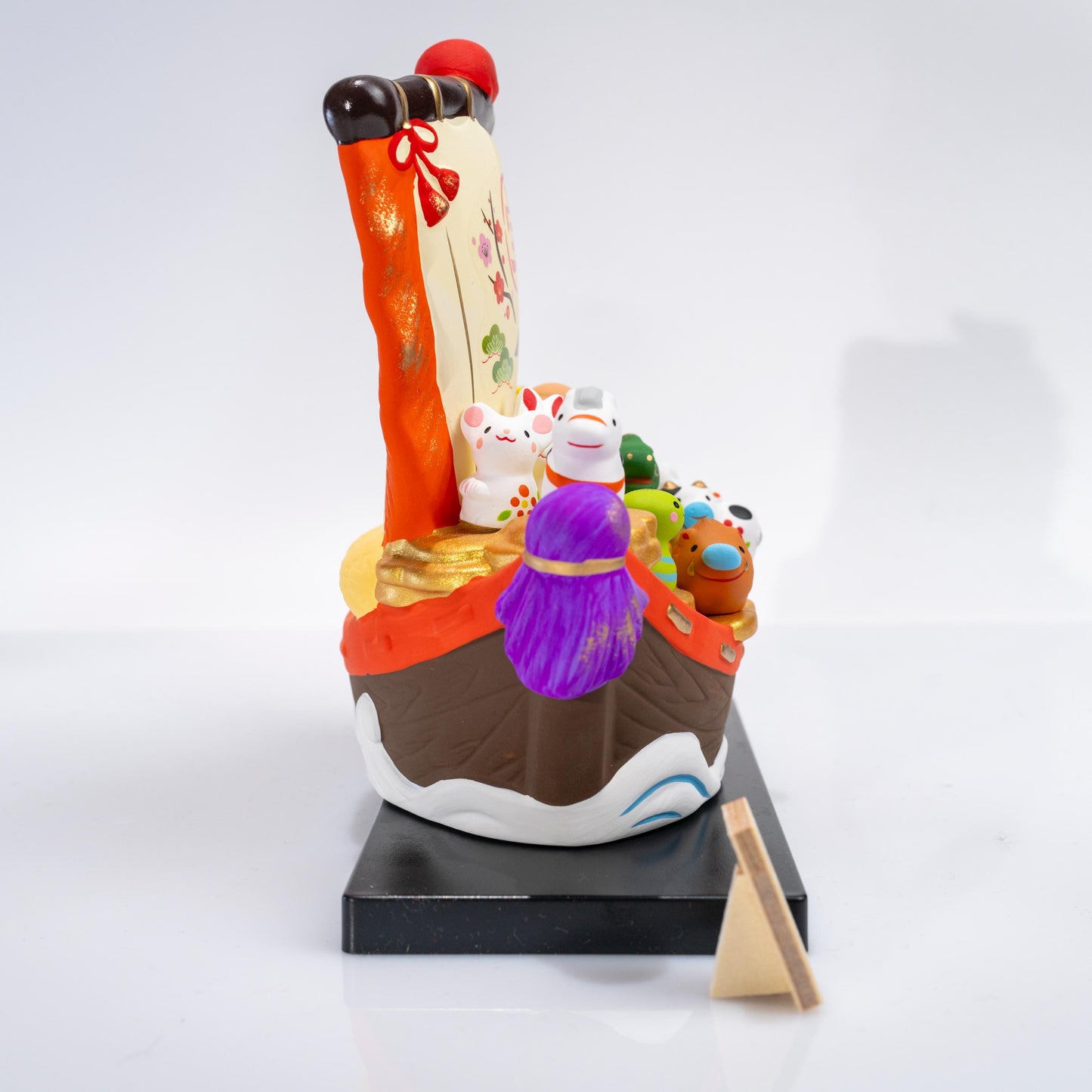 Three-quarter view of zodiac treasure boat figurine set