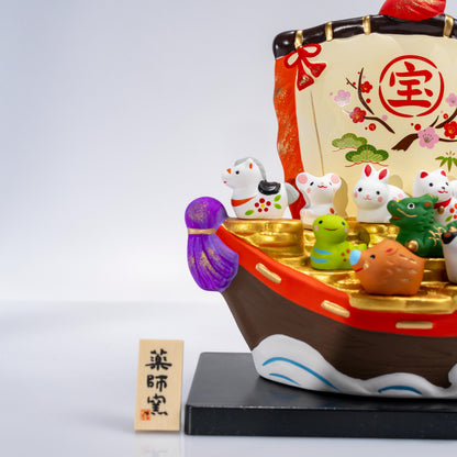 Decorative front detail of ceramic fortune boat and zodiac figures