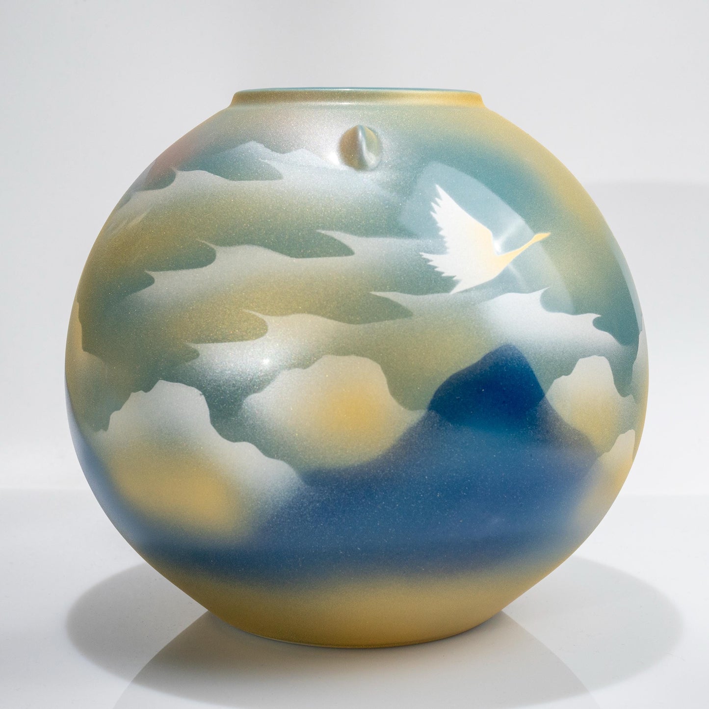 Full body view of round Japanese porcelain crane vase
