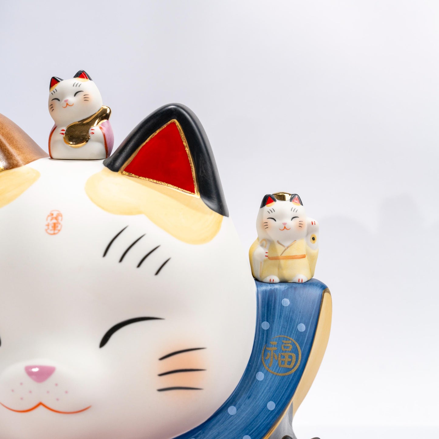 Full display view of large lucky cat figurine with piggy bank design