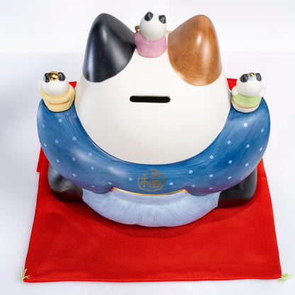 Three-quarter view of large lucky cat coin bank