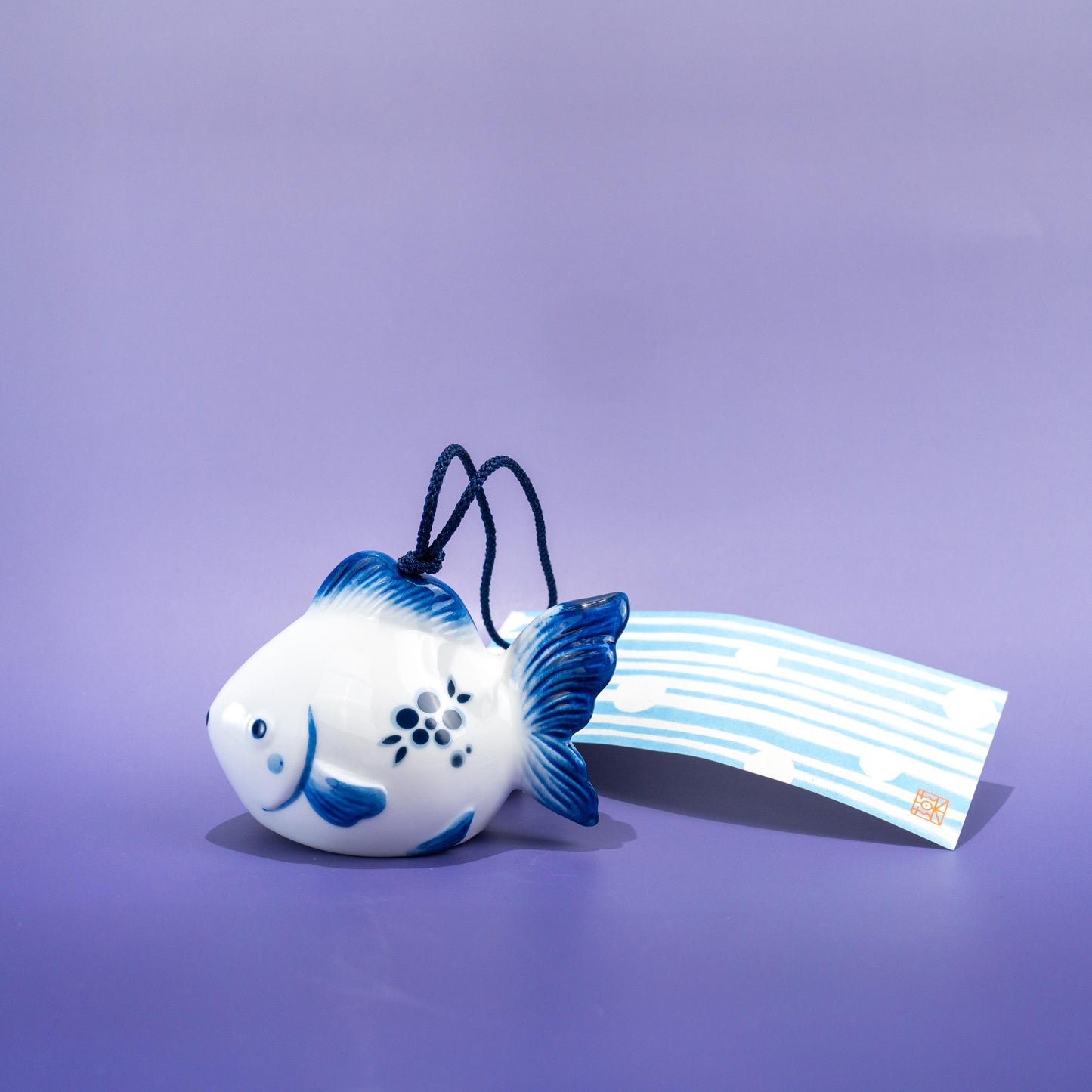 Close-up of hanging string and paper strip on wind chime