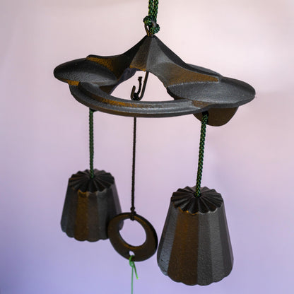 Close-up of cast iron bells and green paper strip 