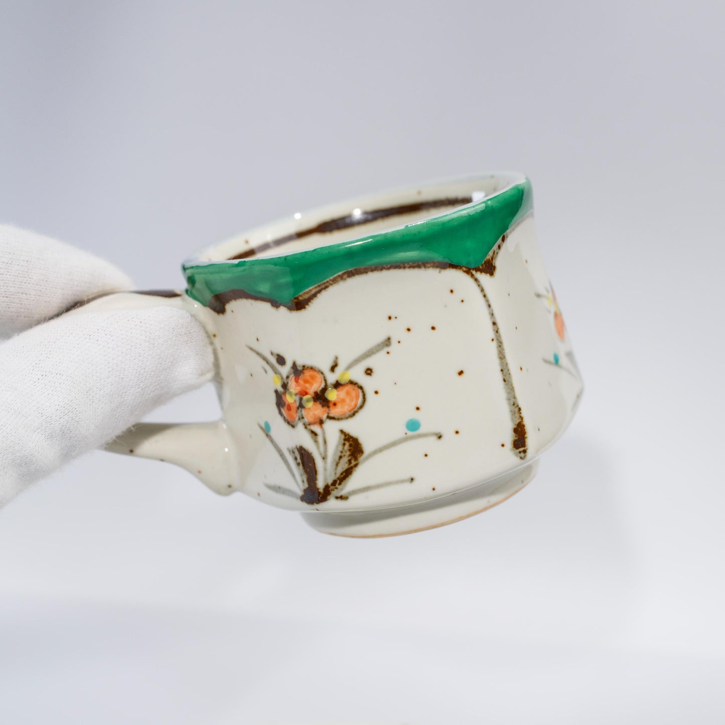 Angled view of hand-painted Arita espresso cup with hexagon body