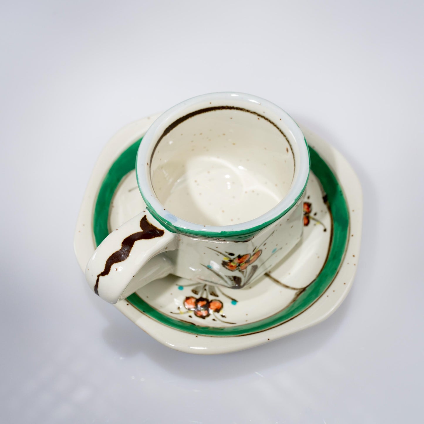 Top view of green floral demitasse cup and saucer in Arita porcelain