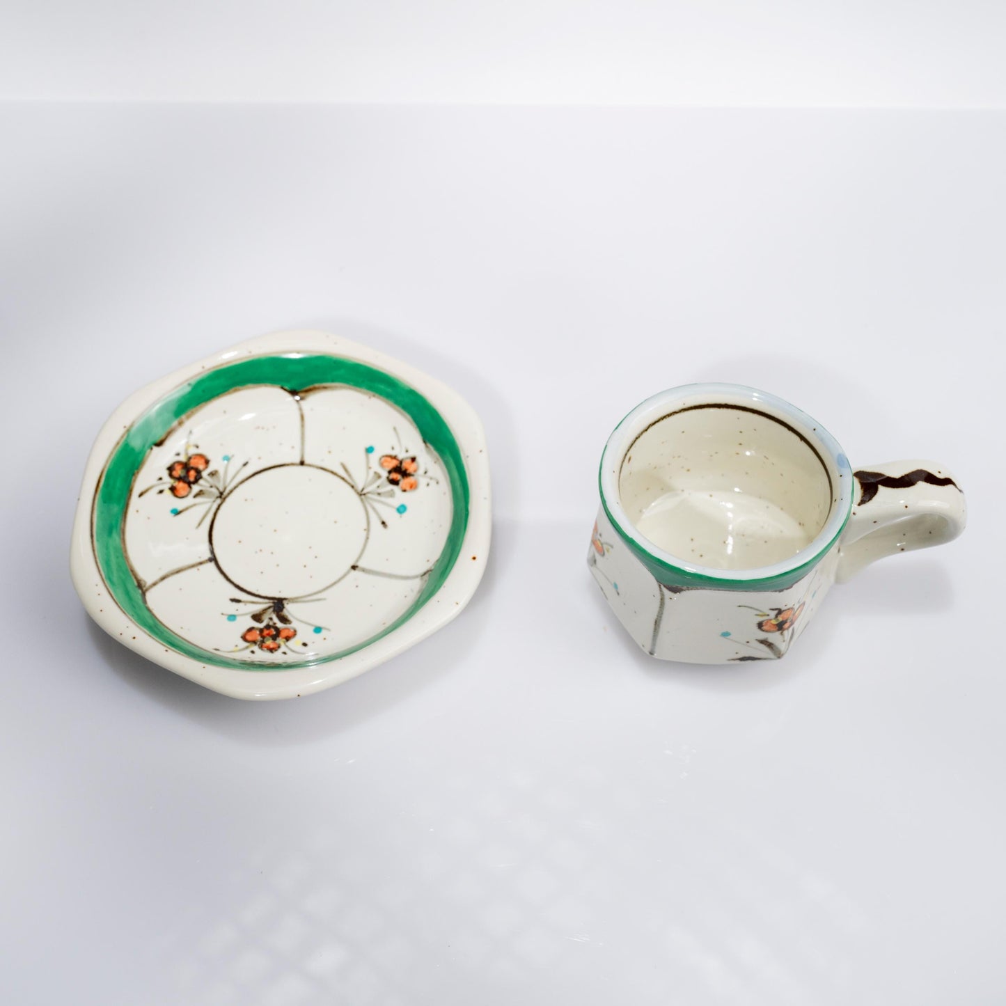 Close-up of green floral detail on Arita demitasse cup