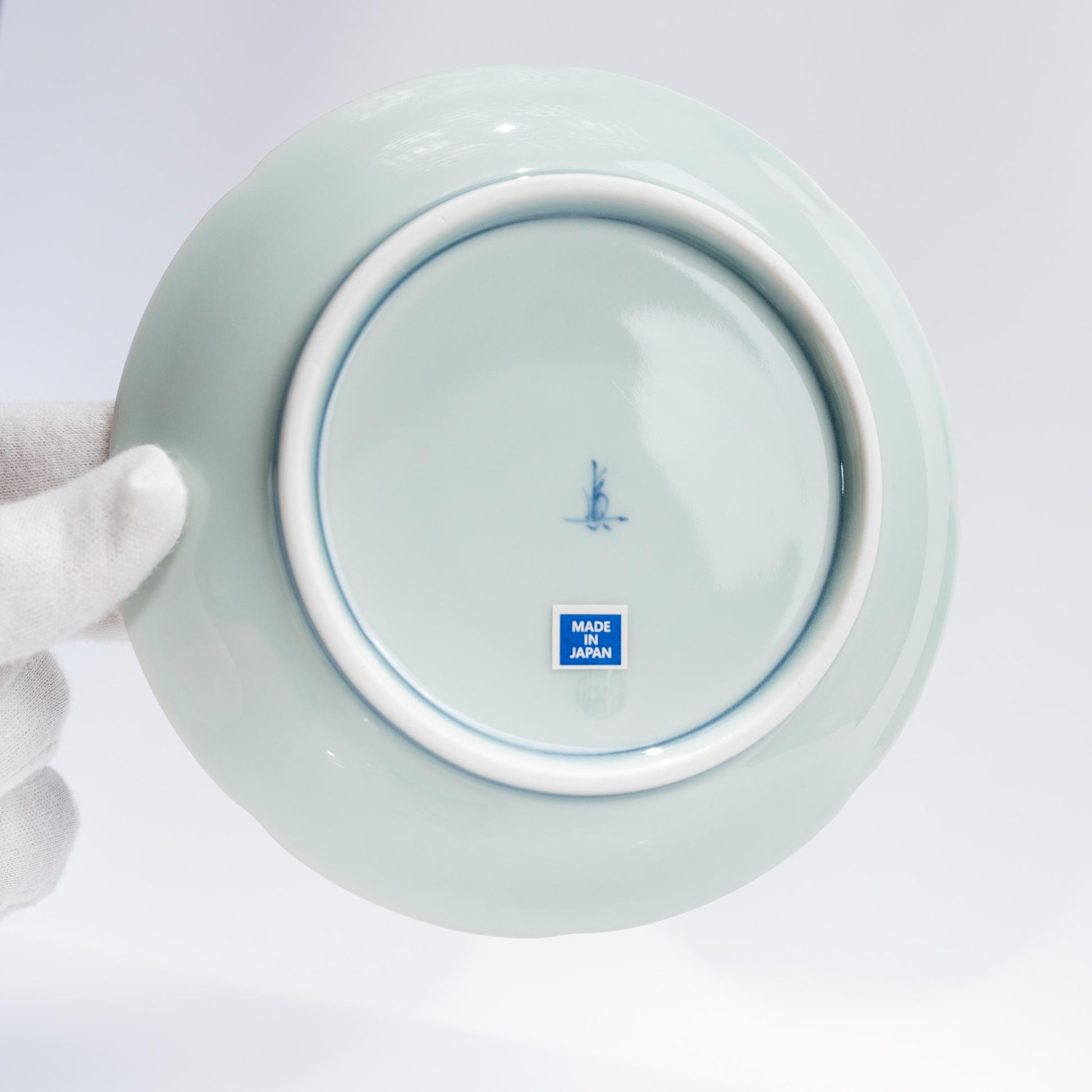 Front view of Japanese porcelain coffee cup and saucer on white background