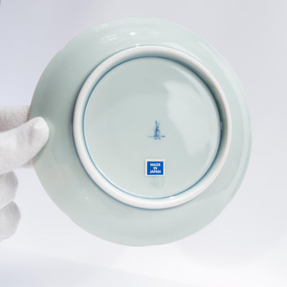 Front view of Japanese porcelain coffee cup and saucer on white background