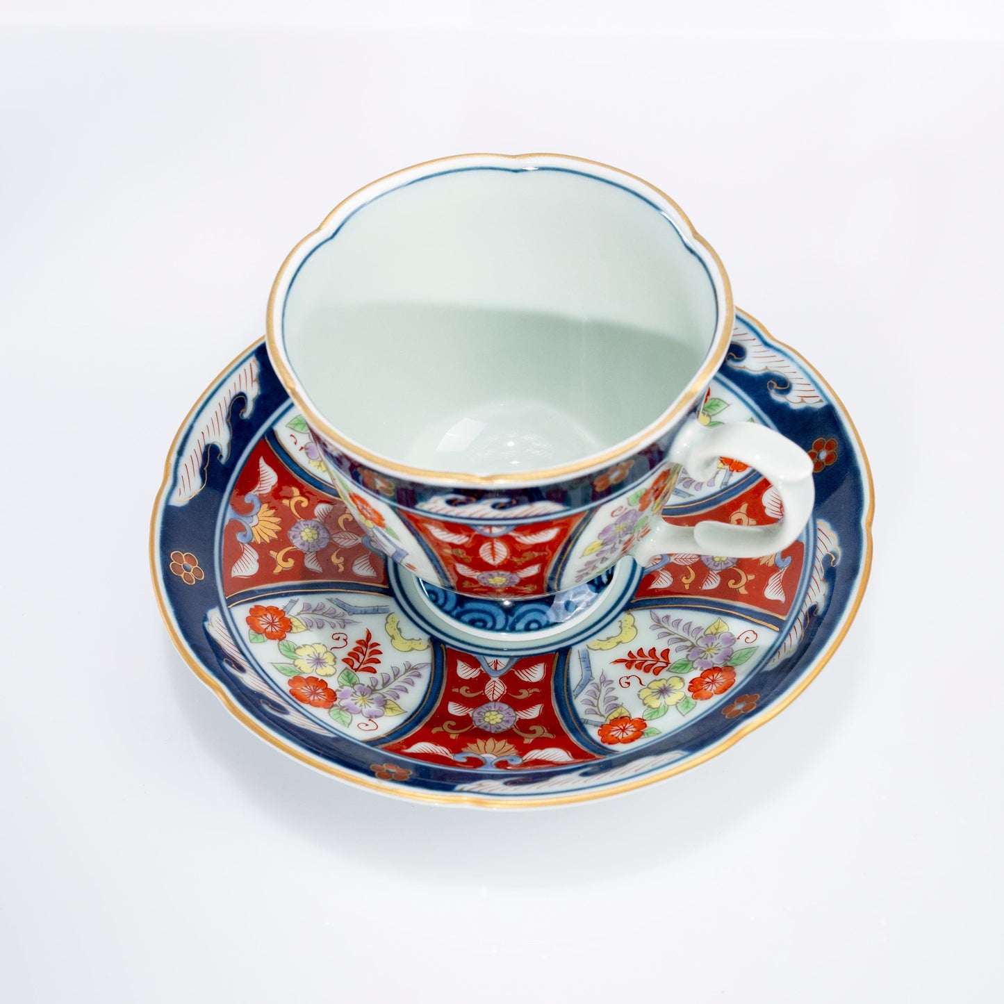 Close-up of cup handle and painted floral detail