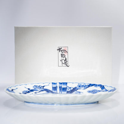 Front view of Arita blue and white serving plate on white background