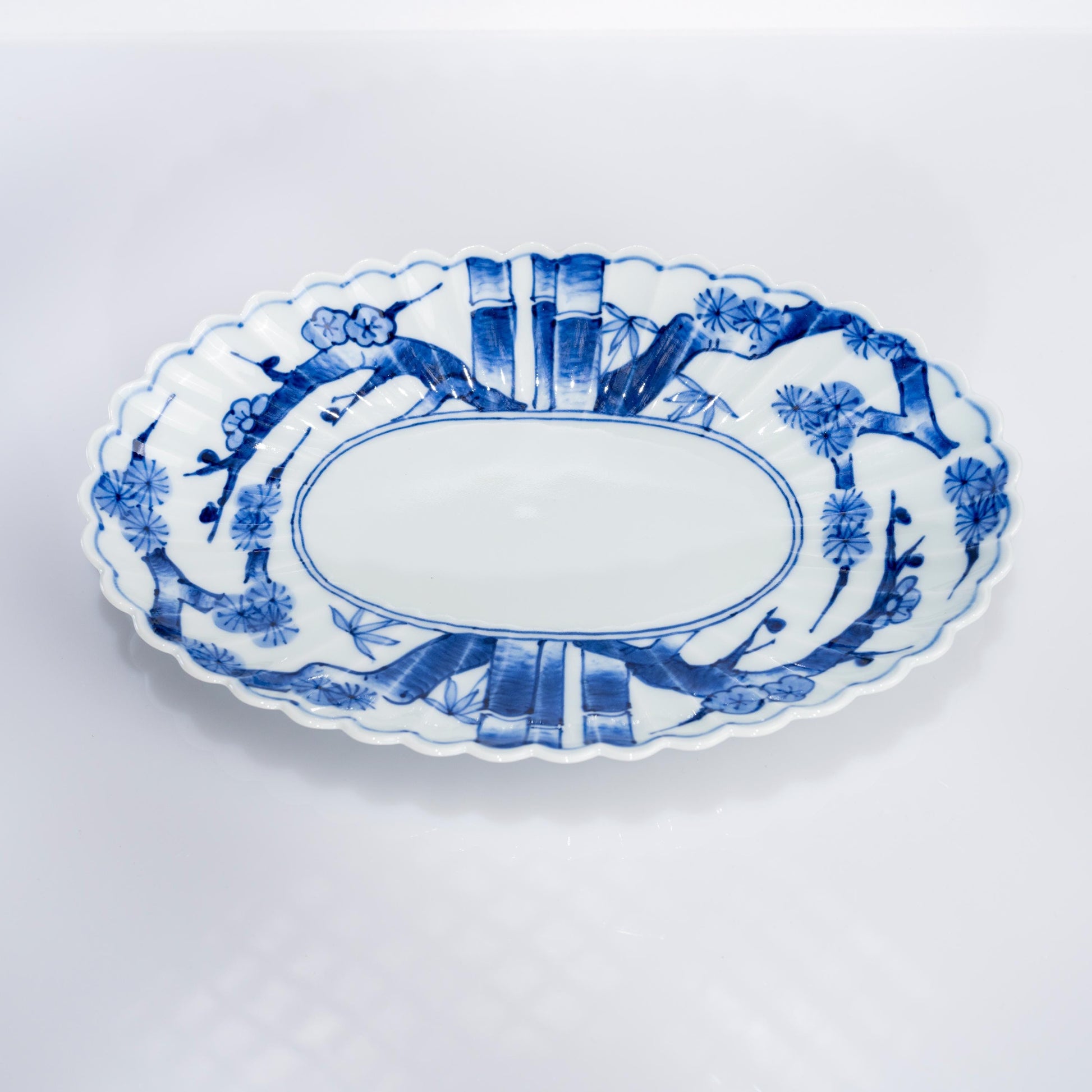 Top view of oval plate showing chrysanthemum-shaped rim