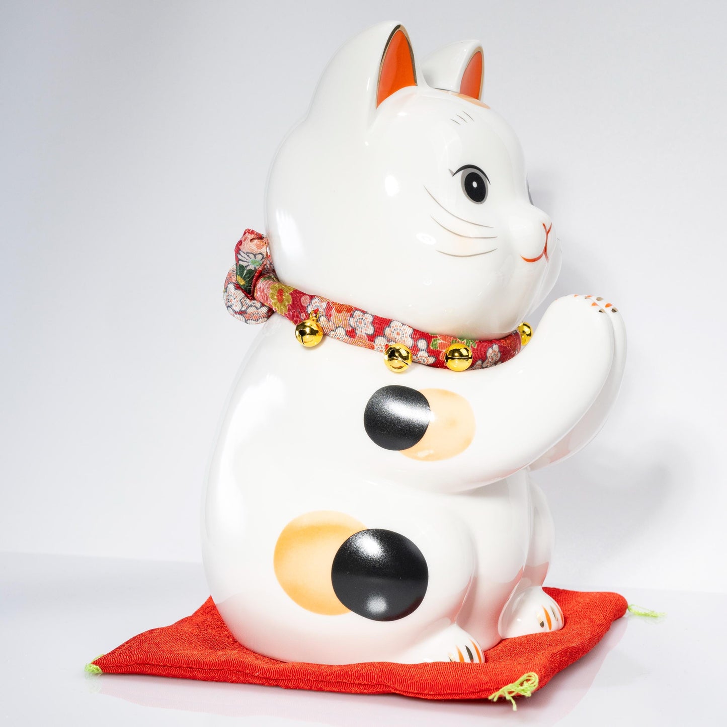 Front view of ceramic lucky cat piggy bank