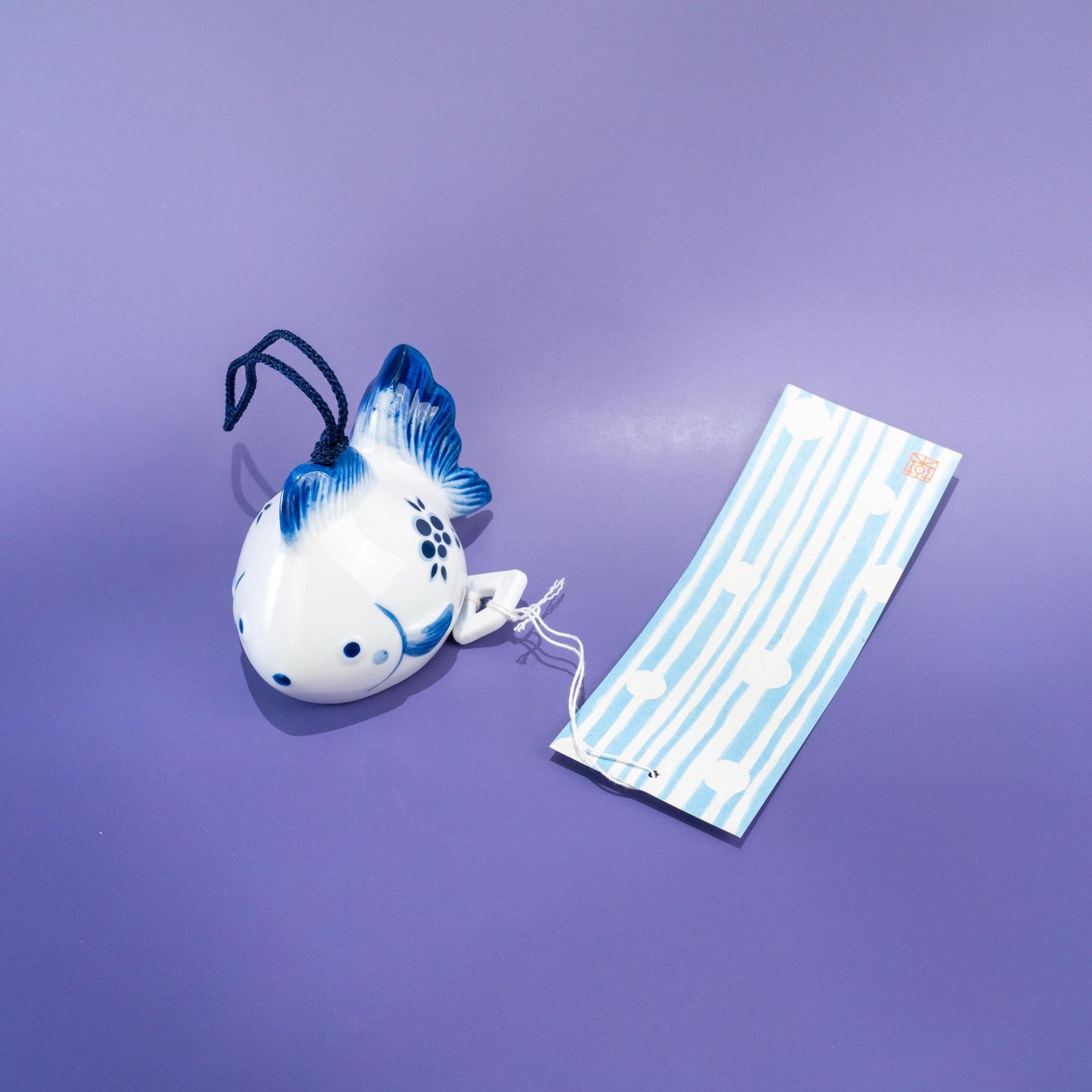 Side view of ceramic fish-shaped wind chime