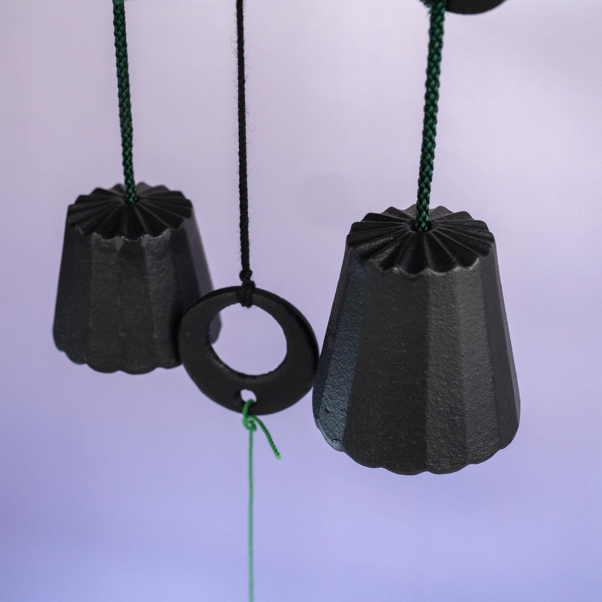 Components of cast iron wind chime with bells and hanging strip 