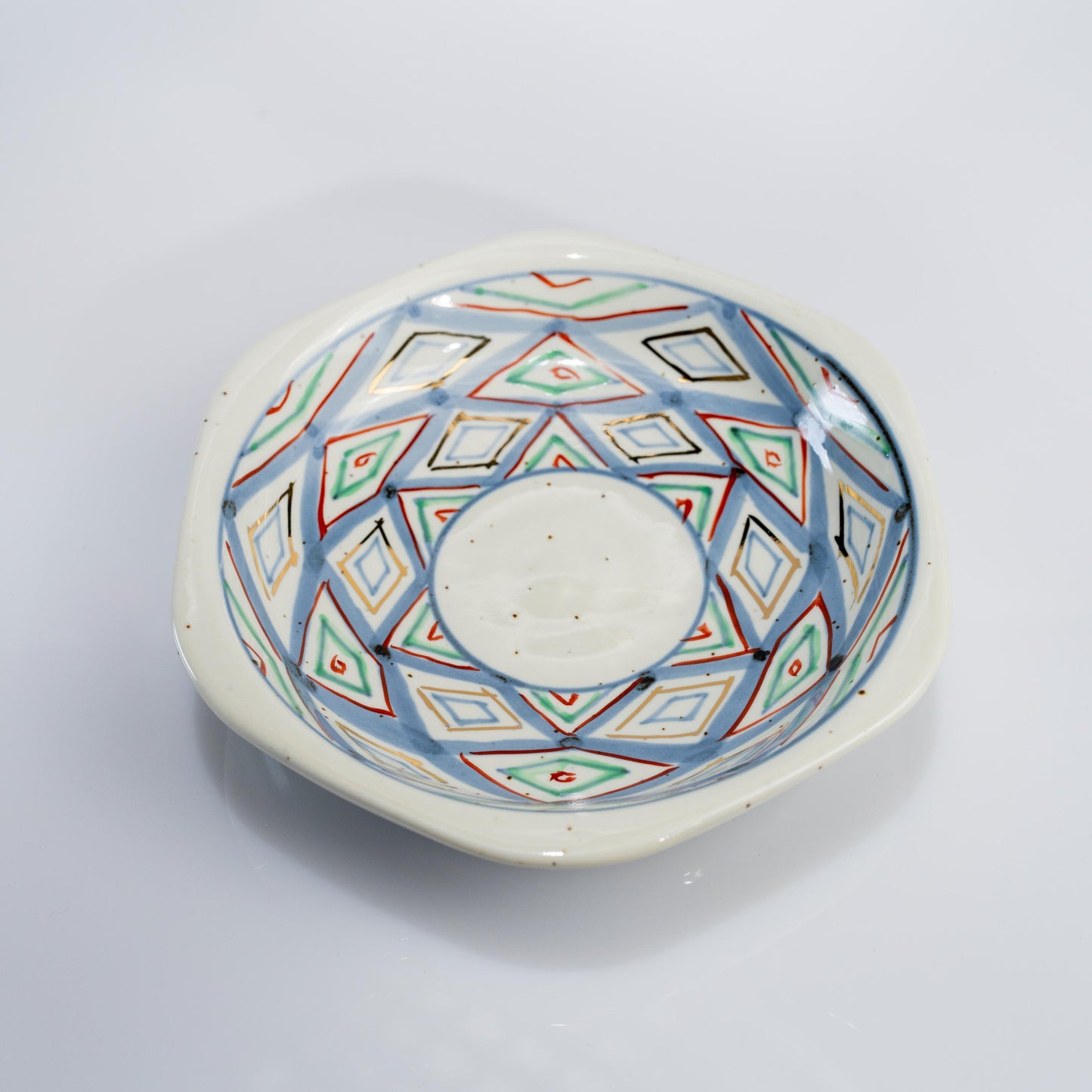 Top view of demitasse cup and saucer with hand-painted diamond pattern