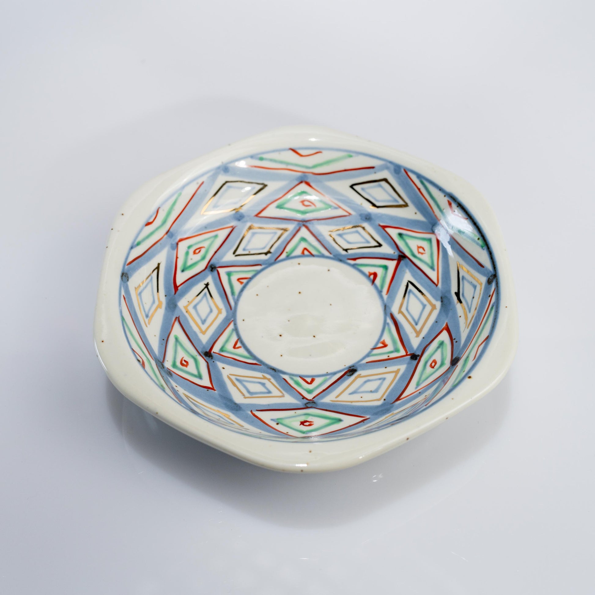 Top view of demitasse cup and saucer with hand-painted diamond pattern