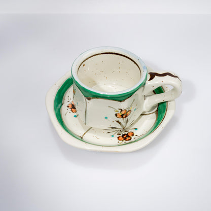 Side view of hand-painted Arita cup with floral motif