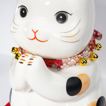 Close-up of painted decoration on maneki neko figurine