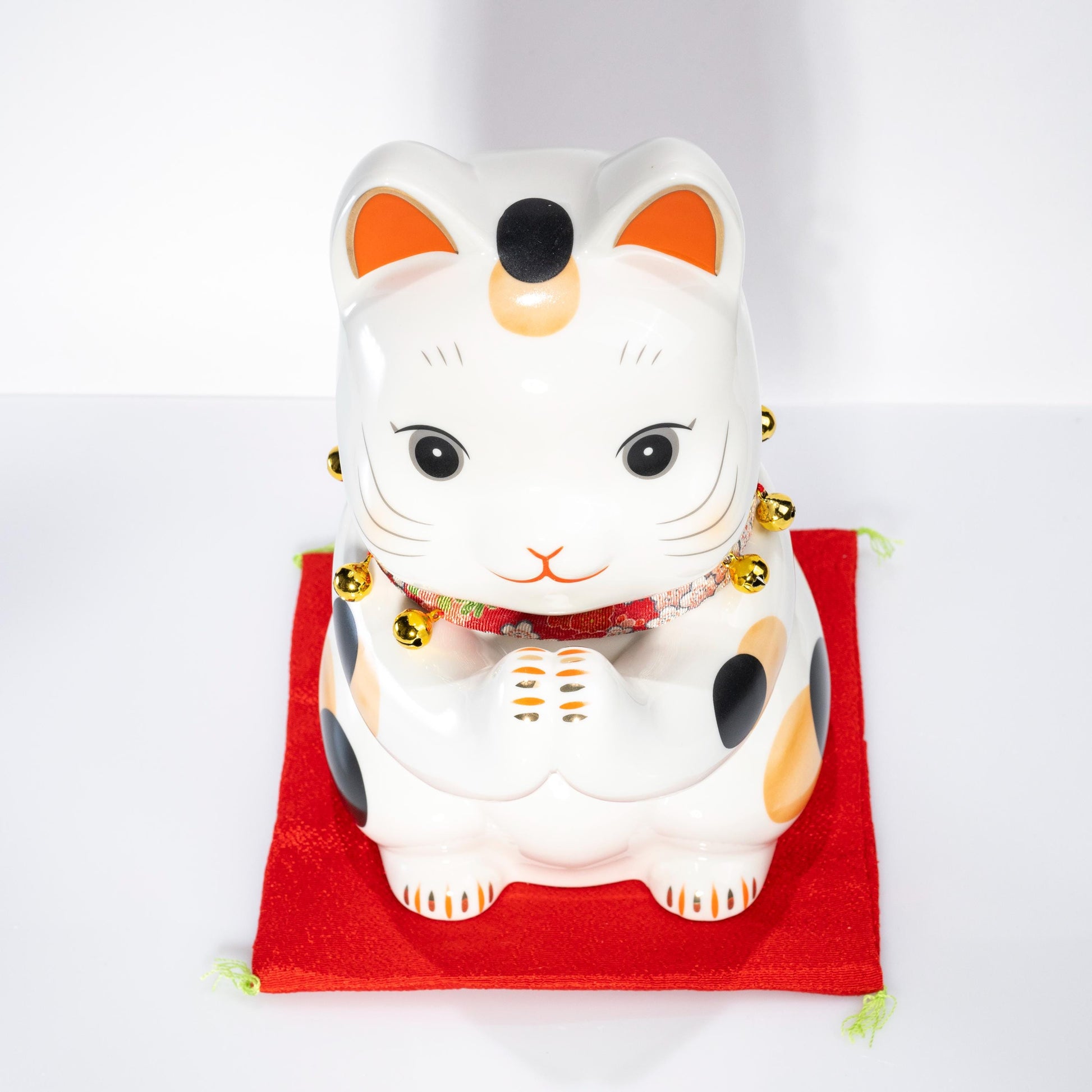 Close-up of face on large maneki neko coin bank
