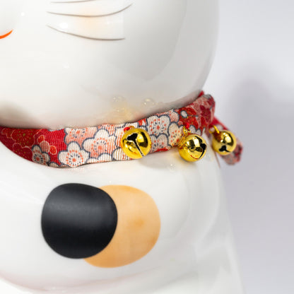 Rear side of lucky cat coin bank showing form