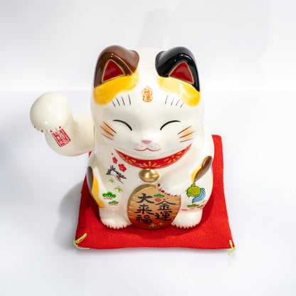 Three-quarter view of electric lucky cat figurine