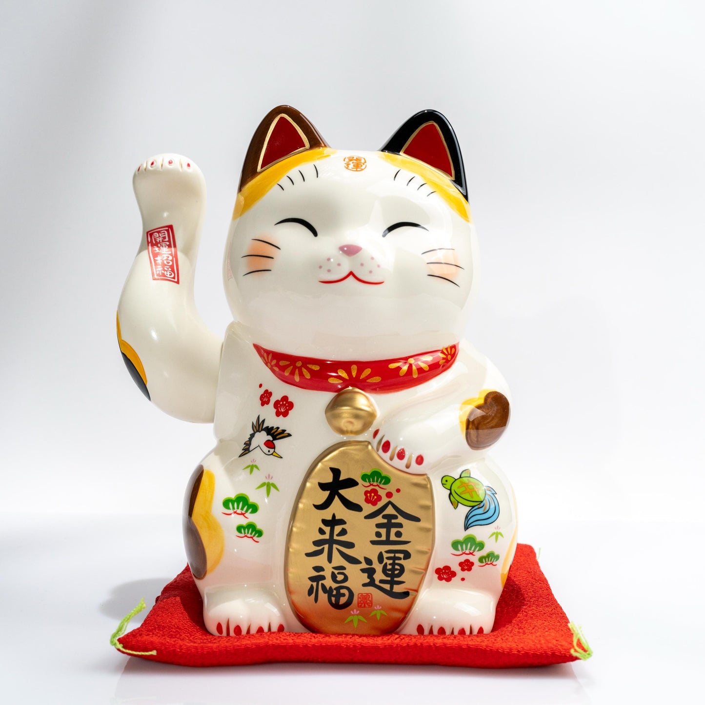 Electric waving Maneki Neko figurine on red base