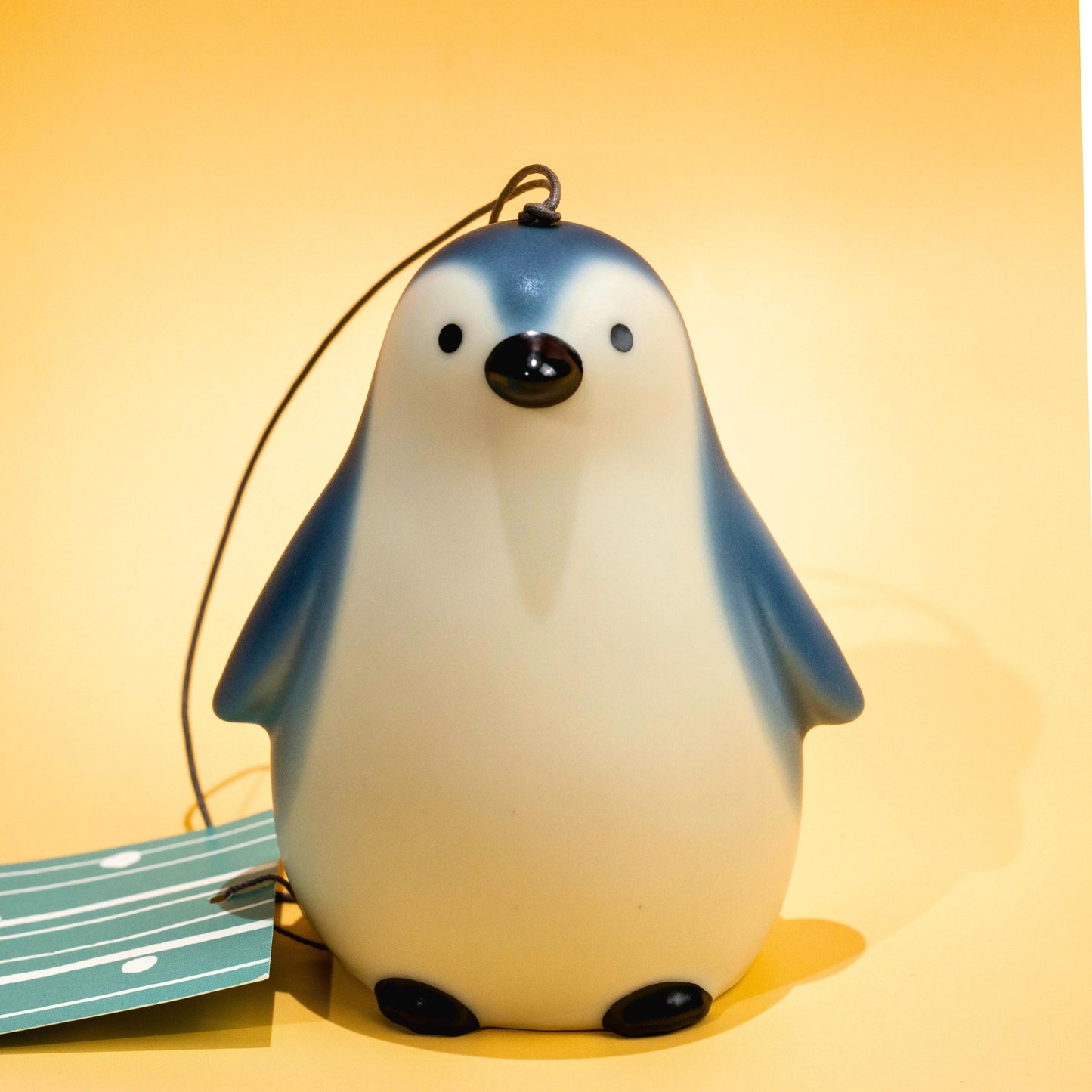Close-up of penguin-shaped ceramic bell