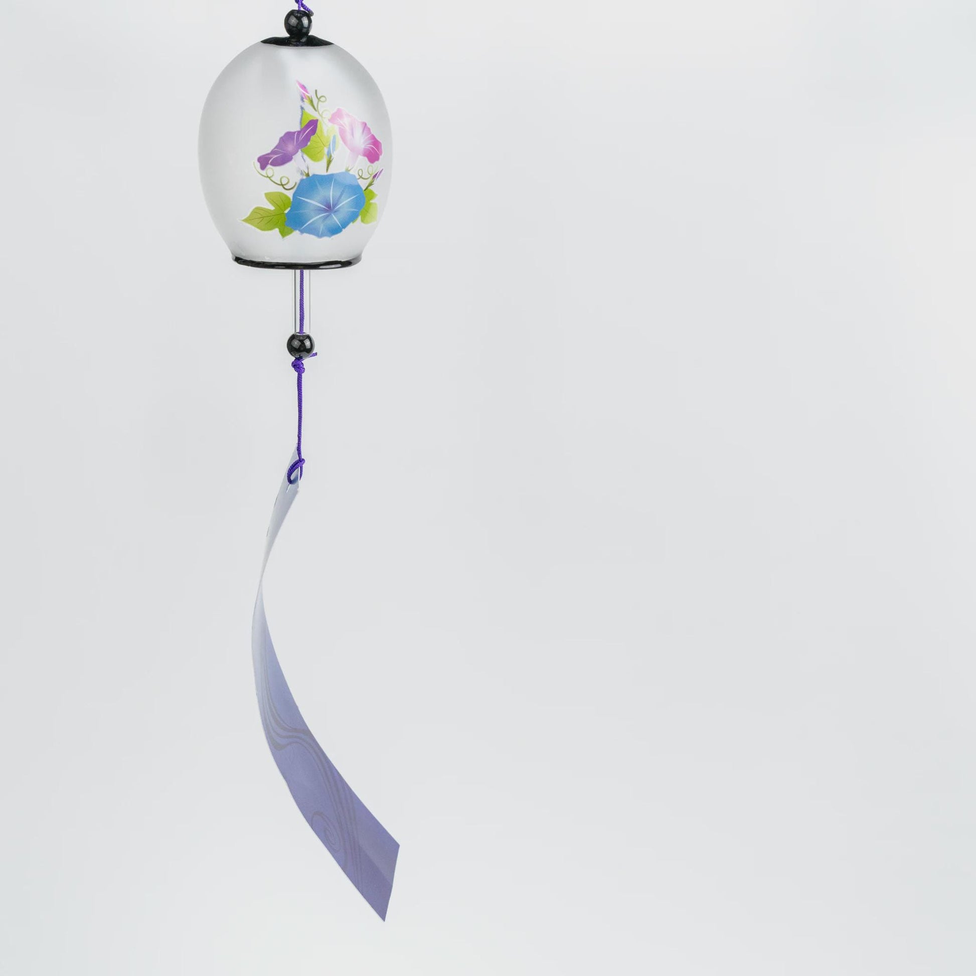 Japanese glass bon furin wind chime with morning glory blossoms in pink, blue and purple on a frosted bell