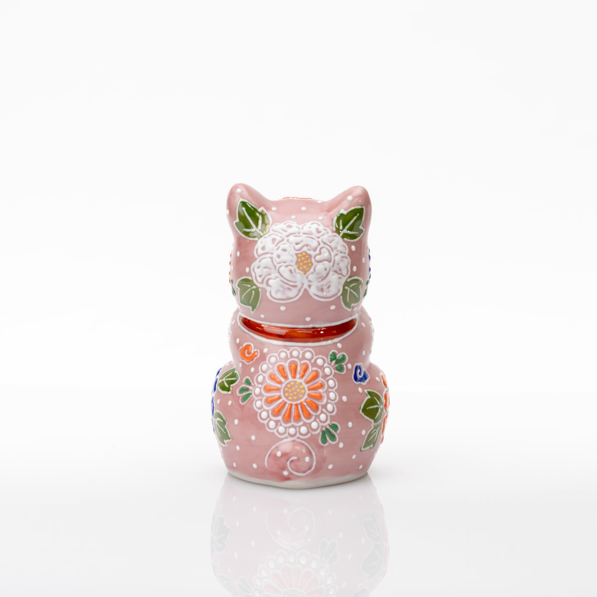Back view of the pink Kutani cat showing a white flower on the head and an orange flower on the body.