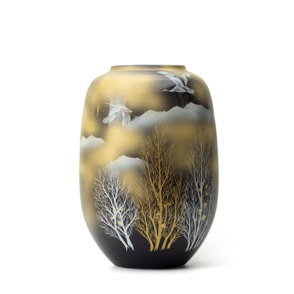 Tall rounded Kutani vase with flying cranes and bare trees against a black-and-gold background.