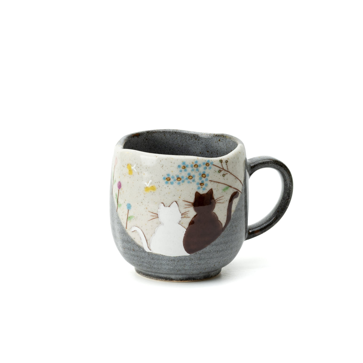 Front view of the gray Kutani Hidamari mug with white and dark cats beneath a flowering branch.