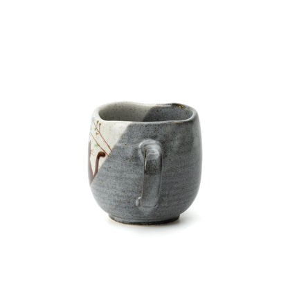 Handle-side view of the Kutani Hidamari mug, showing its gray textured finish and dark interior.