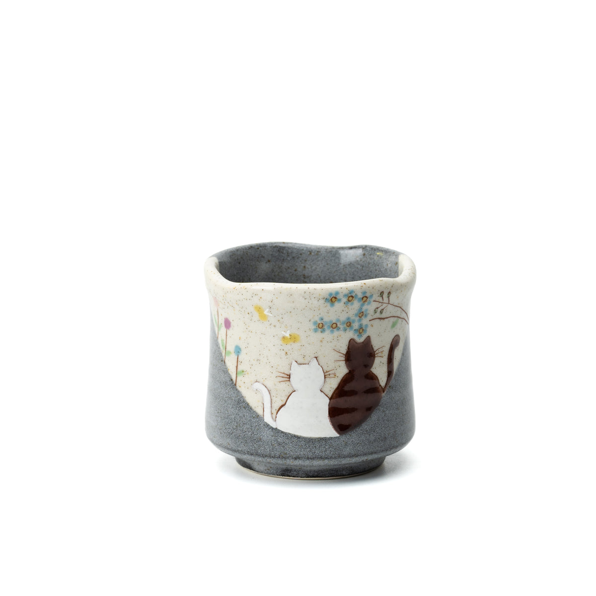 Gray Kutani yunomi with two cats beneath flowering branches, shown on a white background.