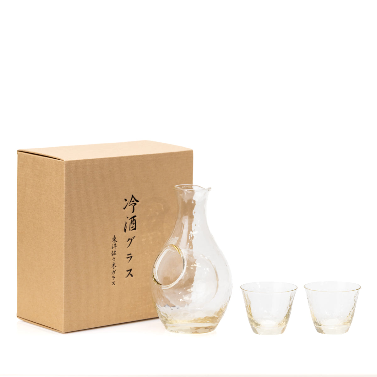 Glass sake carafe and two cups beside their presentation box.
